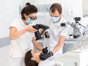 Professional dentist taking photo of patient teeth